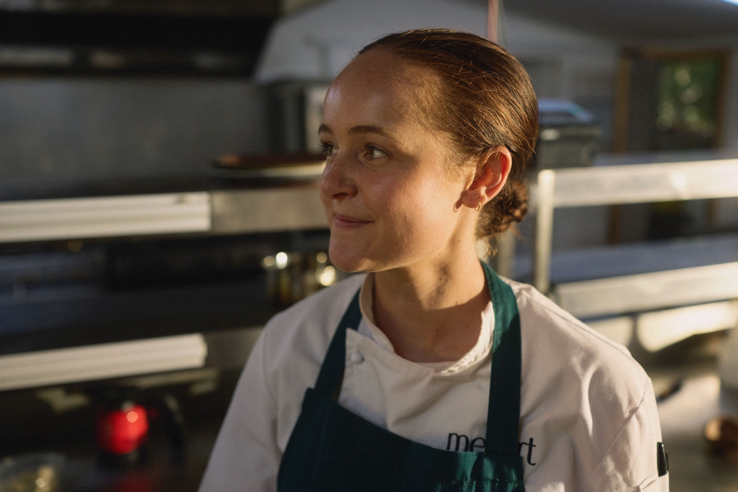A chef photographed in her kitchen at golden hour